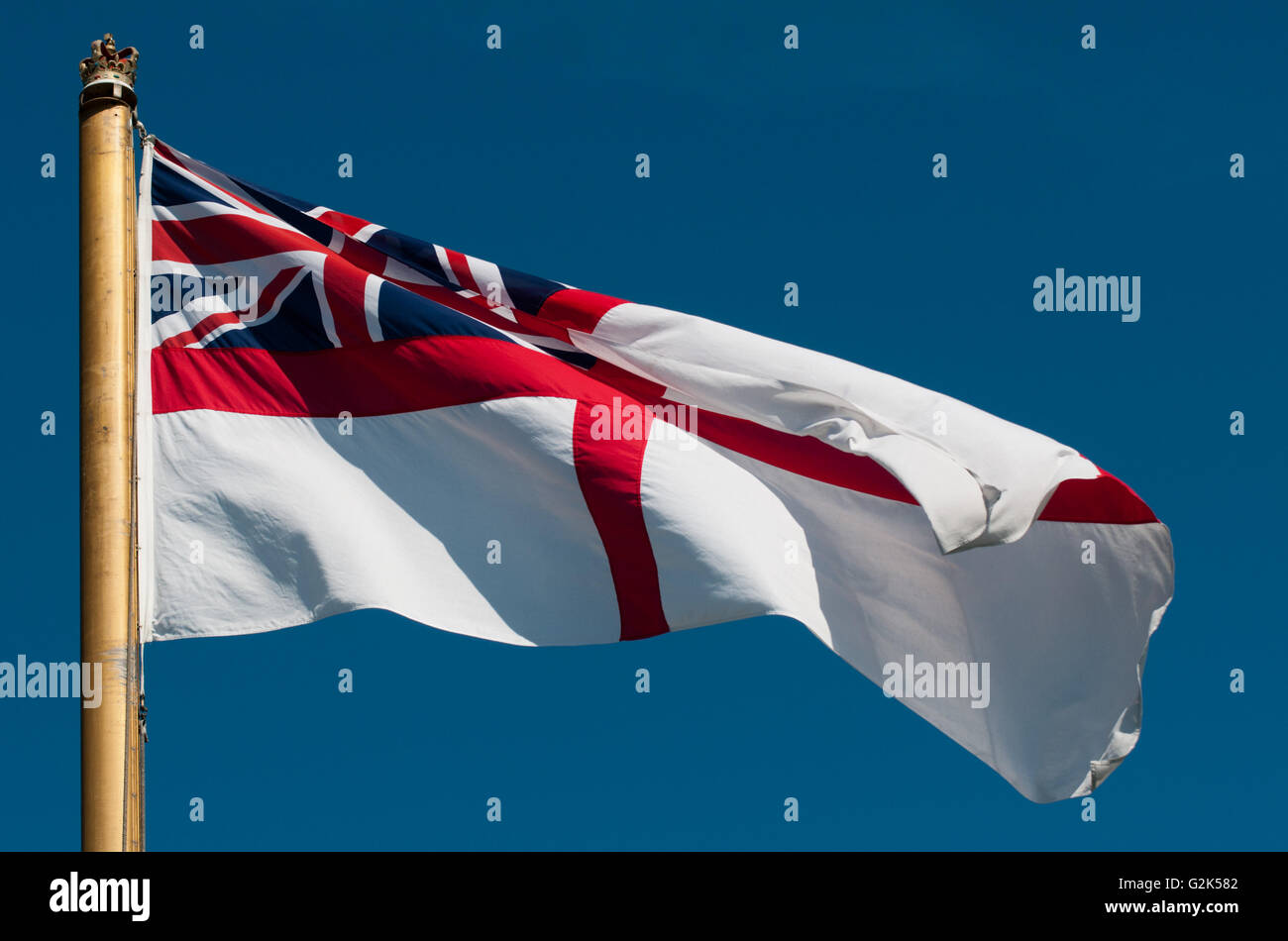 The White Ensign the flag of the Royal Navy which is flown by warships, submarines and establishments. Stock Photo