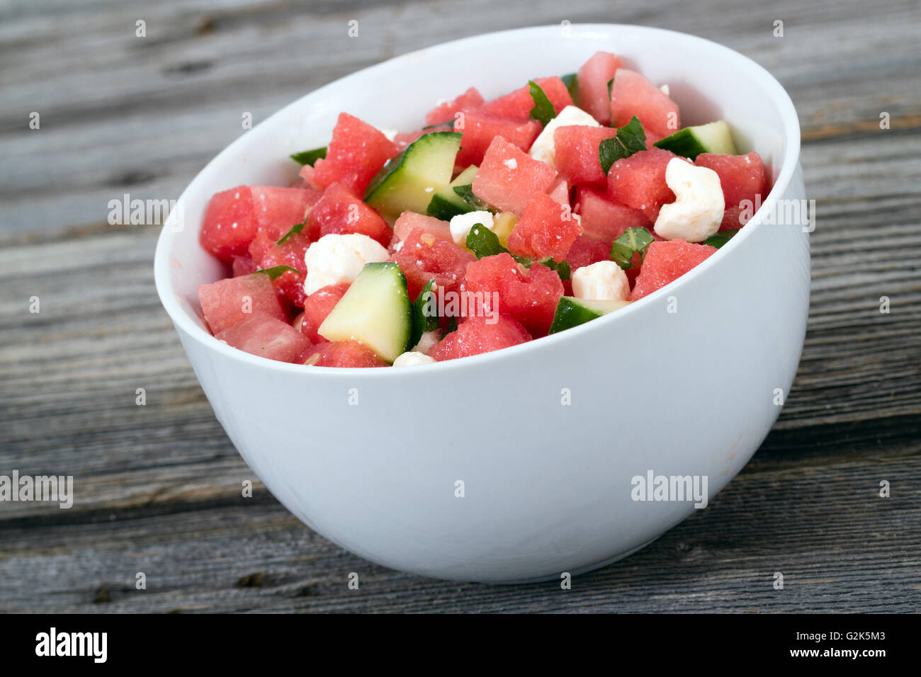 melon feta mint and cucumber healthy summer salad bowl closeup Stock Photo
