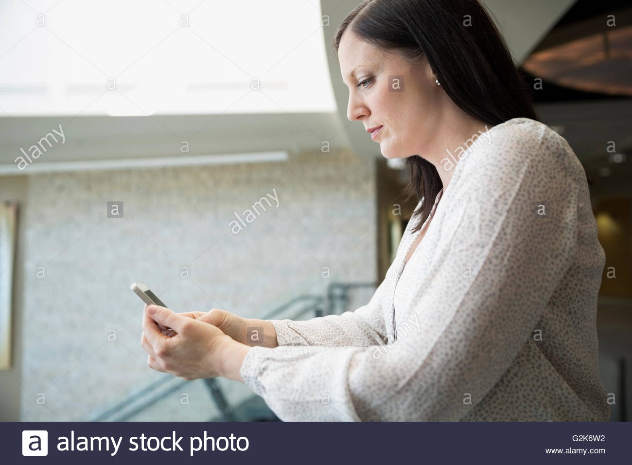 Serious woman texting Stock Photo