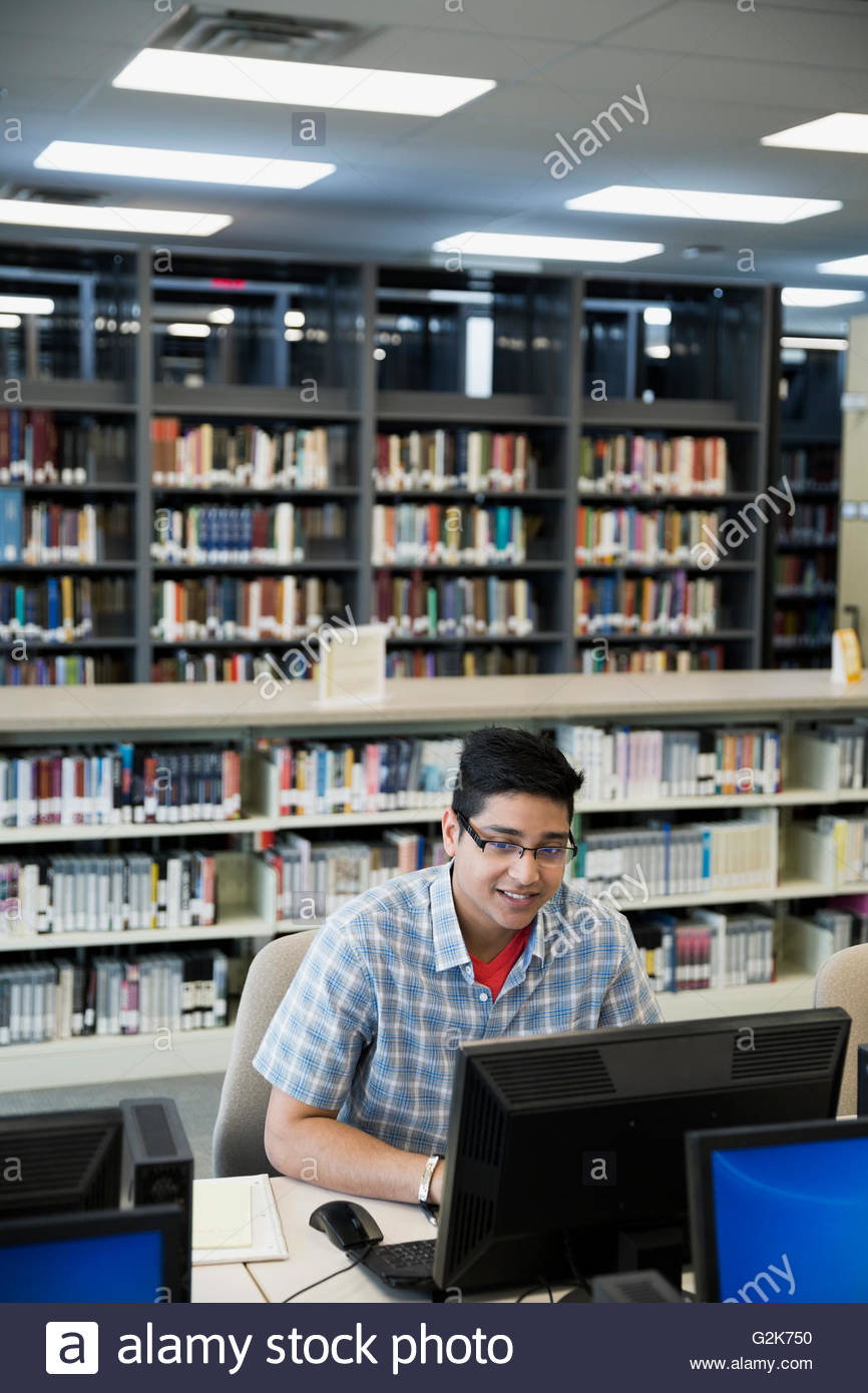 College student researching at computer in library Stock Photo - Alamy