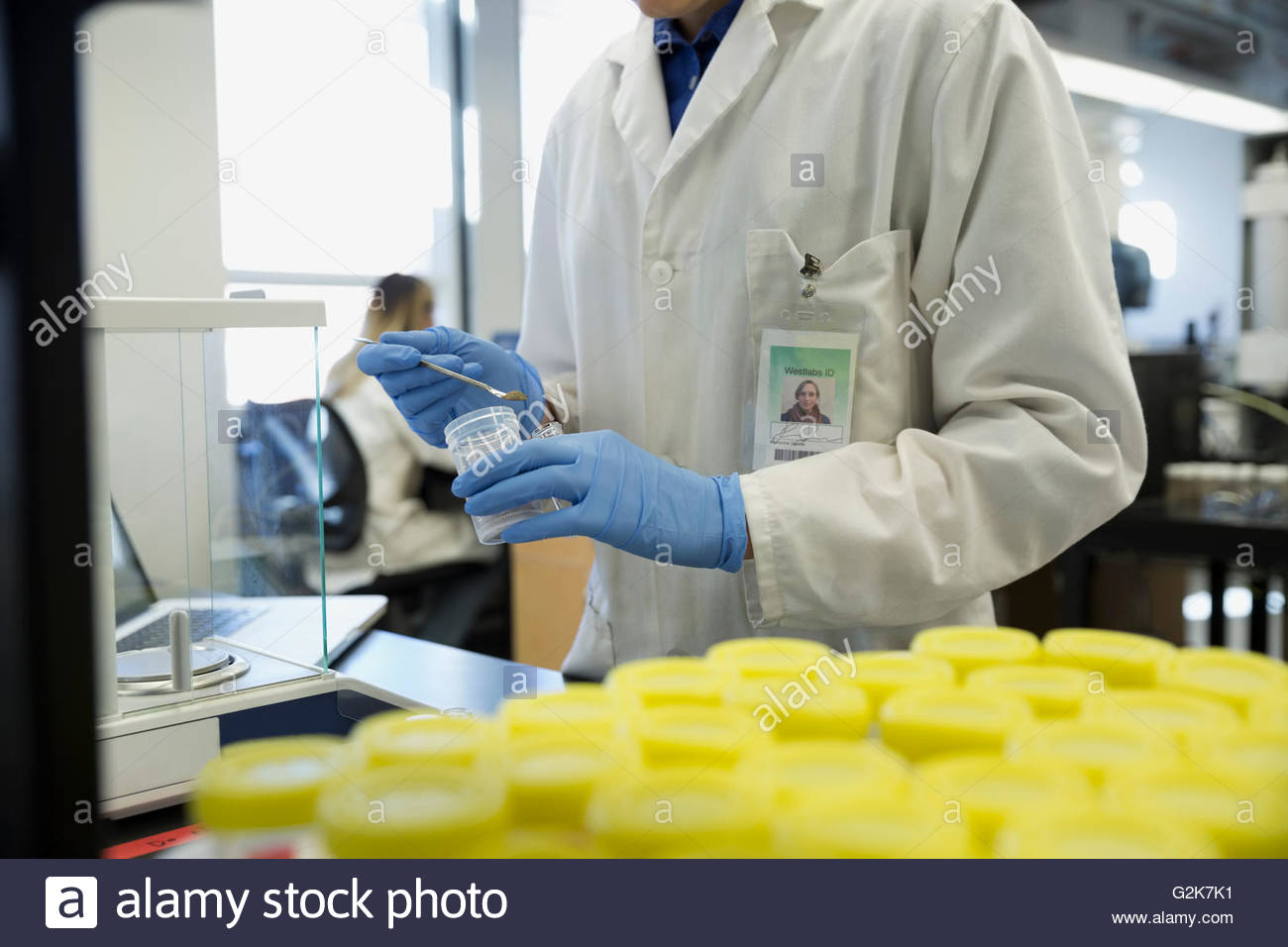 Scientist removing specimen from bottle in laboratory Stock Photo Alamy