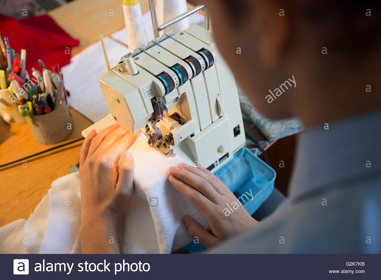 Dressmaker using sewing machine Stock Photo Alamy