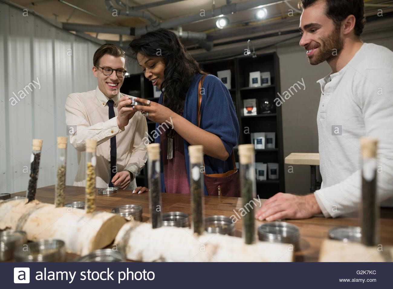 Tea shop owner showing tea to customers Stock Photo Alamy