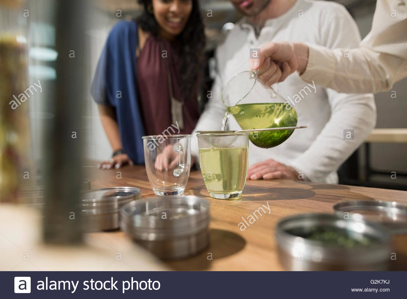Tea shop owner pouring green tea for customers Stock Photo Alamy