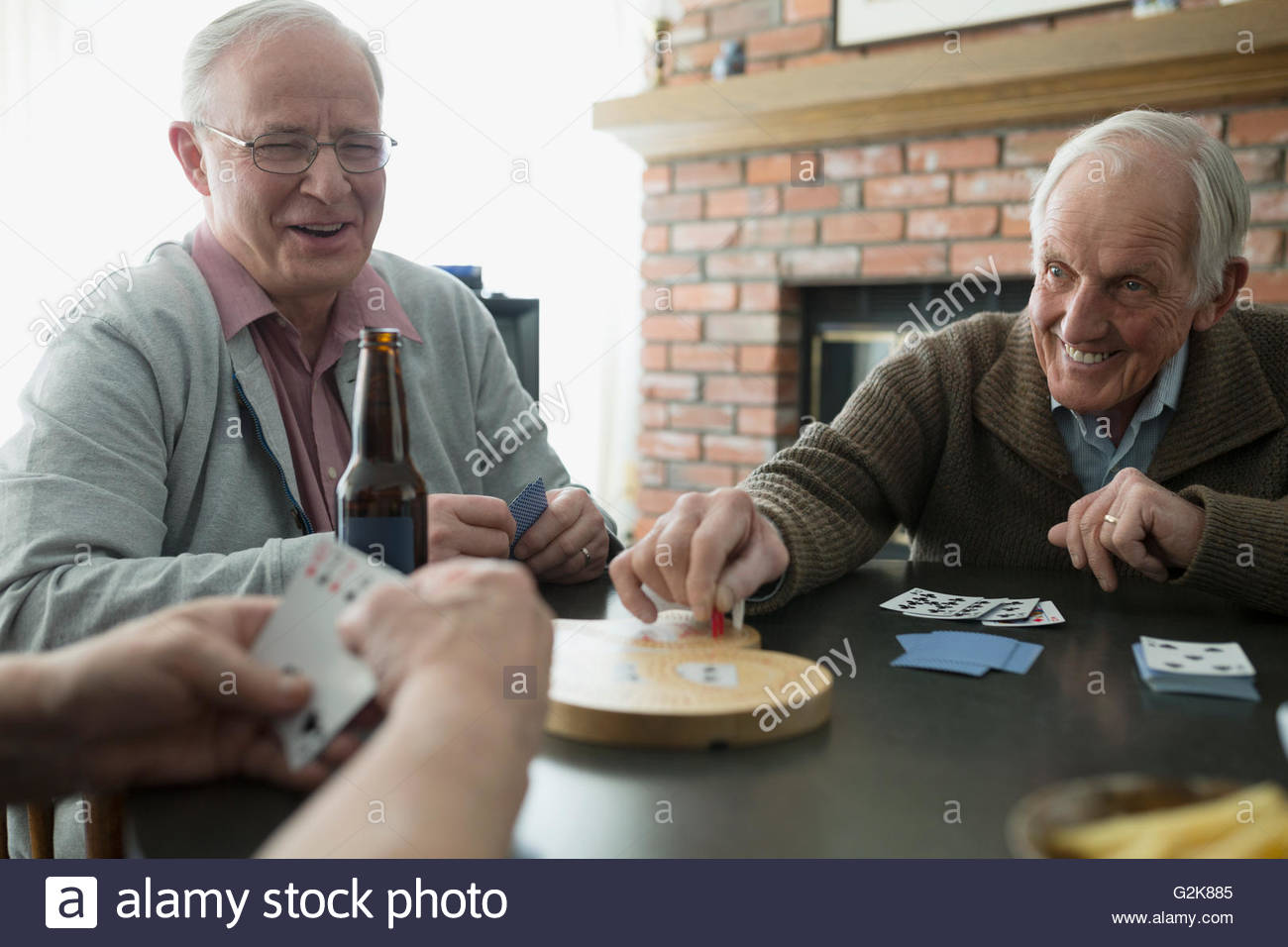 Senior men playing cribbage and drinking beer Stock Photo