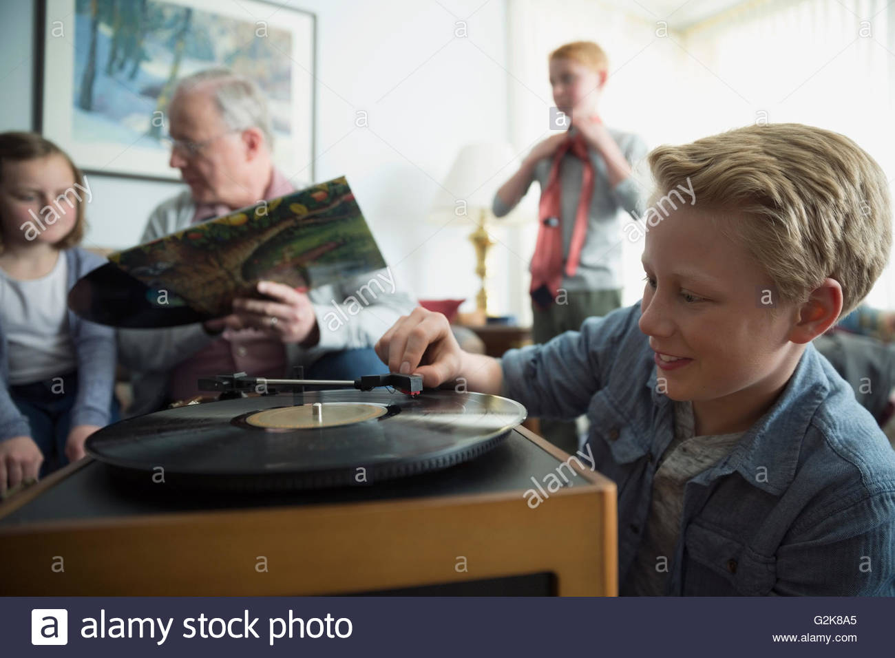 Grandfather and grandchildren listening to old records Stock Photo