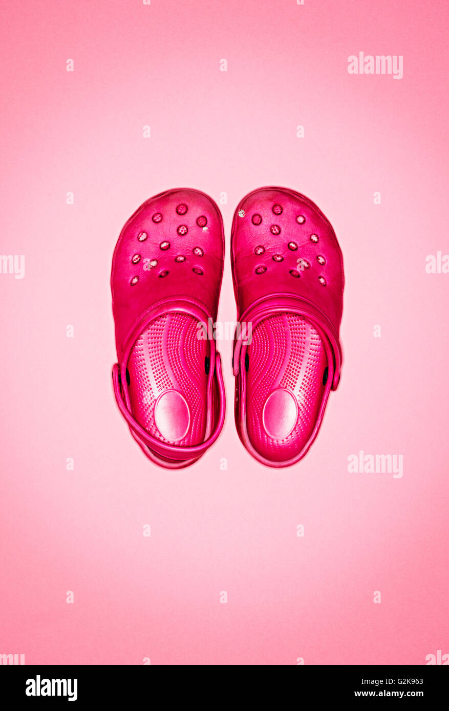 A pair of pink croc shoes Stock Photo
