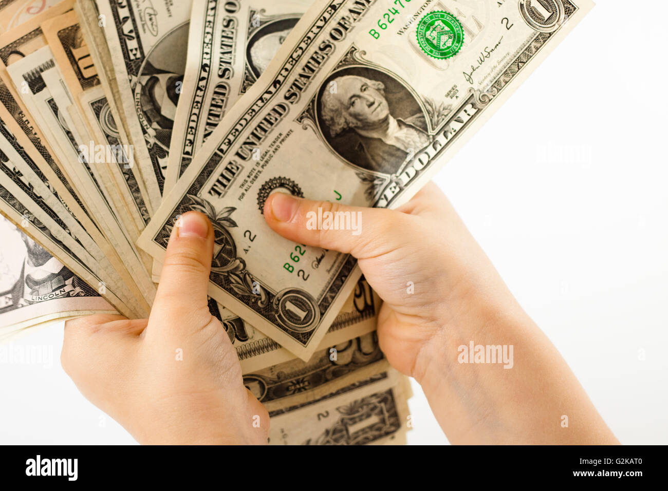two child hands holding dollar bills Stock Photo