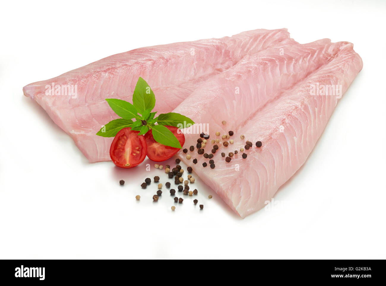 Fillets of Nile perch (Lates niloticus), peppercorns (Piperaceae), tomato (Solanum lycopersicum) and mint (Mentha sp.) Stock Photo