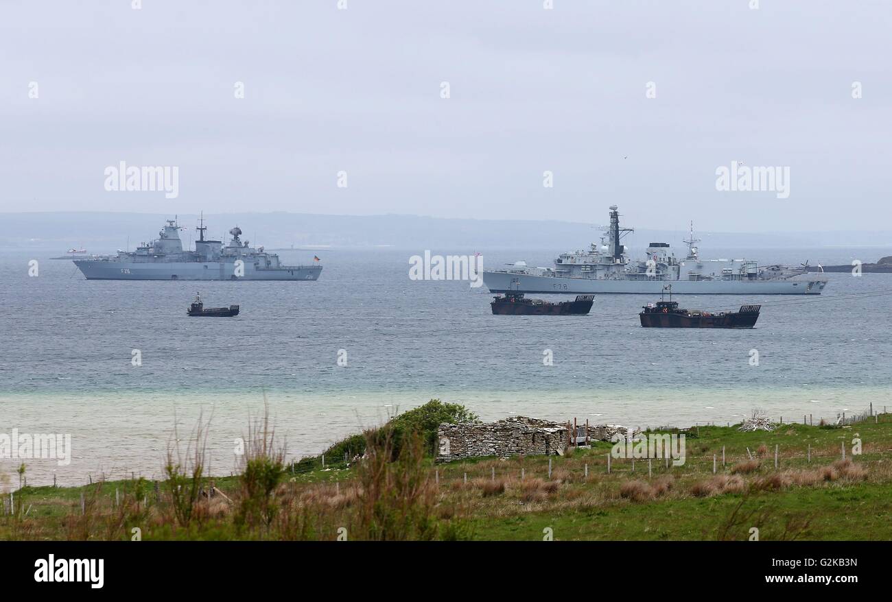 HMS Kent (right) sails alongside SMS Schleswig-Holstein in Scapa Flow before a service at Lyness Cemetery on the island of Hoy, Orkney, to mark the centenary of the Battle of Jutland. Stock Photo