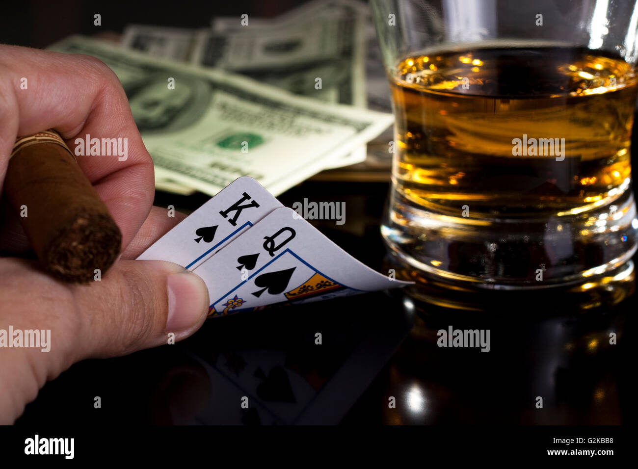 poker playing cards dollars and a whiskey glass Stock Photo
