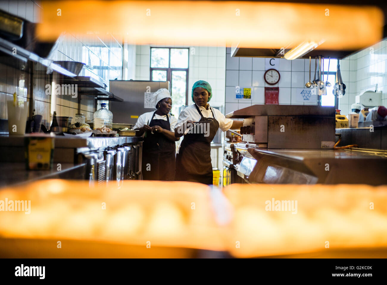 Chefs prepare dishes for lunch at NICE restaurant, Windhoek, Namibia. They start work at 7 o’clock in the morning to be ready for opening at 12 p.m. Chefs make soups, prepare vegetables and snacks, cut basic ingredients for salads. Stock Photo