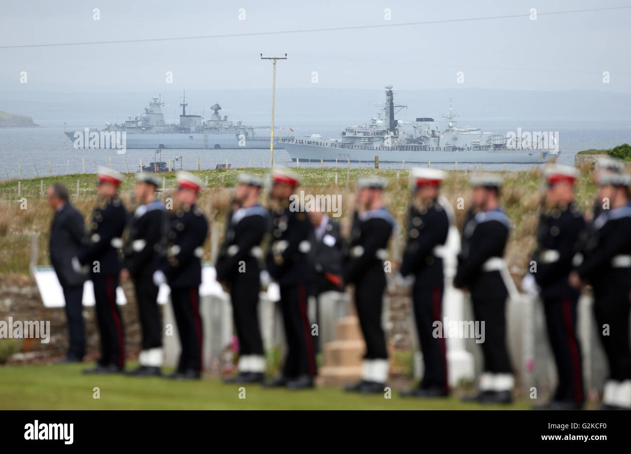 HMS Kent (right) and the German battleship SMS Schleswig-Holstein are moored in Scapa Flow as sailors and descendants of those who fought at the Battle of Jutland attend a service at Lyness Cemetery on the island of Hoy, Orkney, to mark the centenary of the battle. Stock Photo