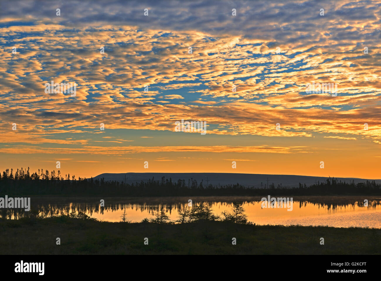 Clouds at sunset over pond Hawke's Bay Newfoundland & Labrador Canada Stock Photo