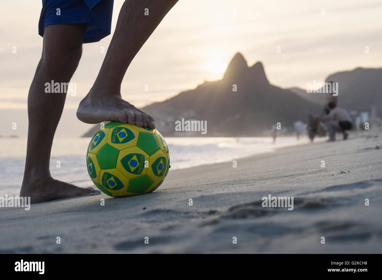 Brazil, Rio De Janeiro, man standing with ball on Ipanema beach Stock Photo