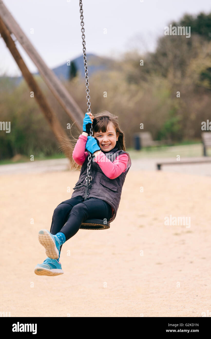 Happy girl on a swing Stock Photo - Alamy