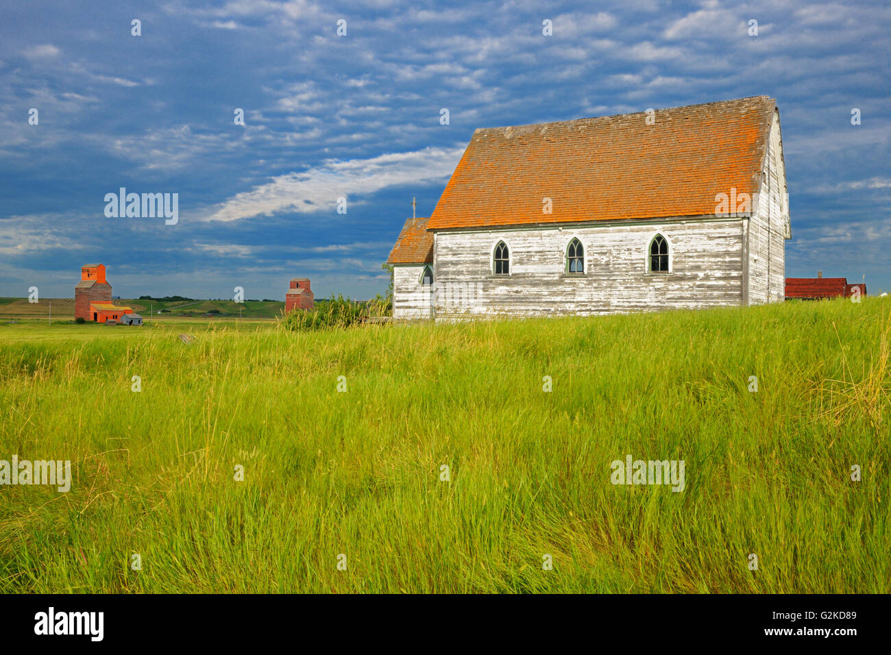 Grain elevators and old church in ghost town, Neidpath, Saskatchewan, Canada Stock Photo