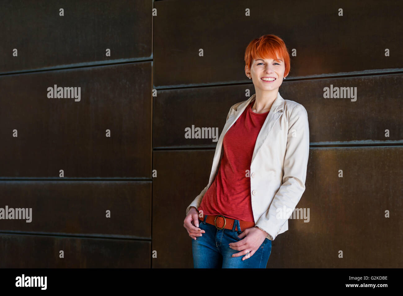 Portrait of smiling redheaded young woman Stock Photo - Alamy