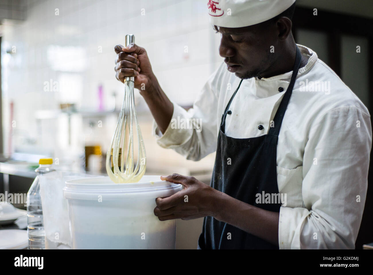 Chefs prepare dishes for lunch at NICE restaurant, Windhoek, Namibia. They start work at 7 o’clock in the morning to be ready for opening at 12 p.m. Chefs make soups, prepare vegetables and snacks, cut basic ingredients for salads. Stock Photo