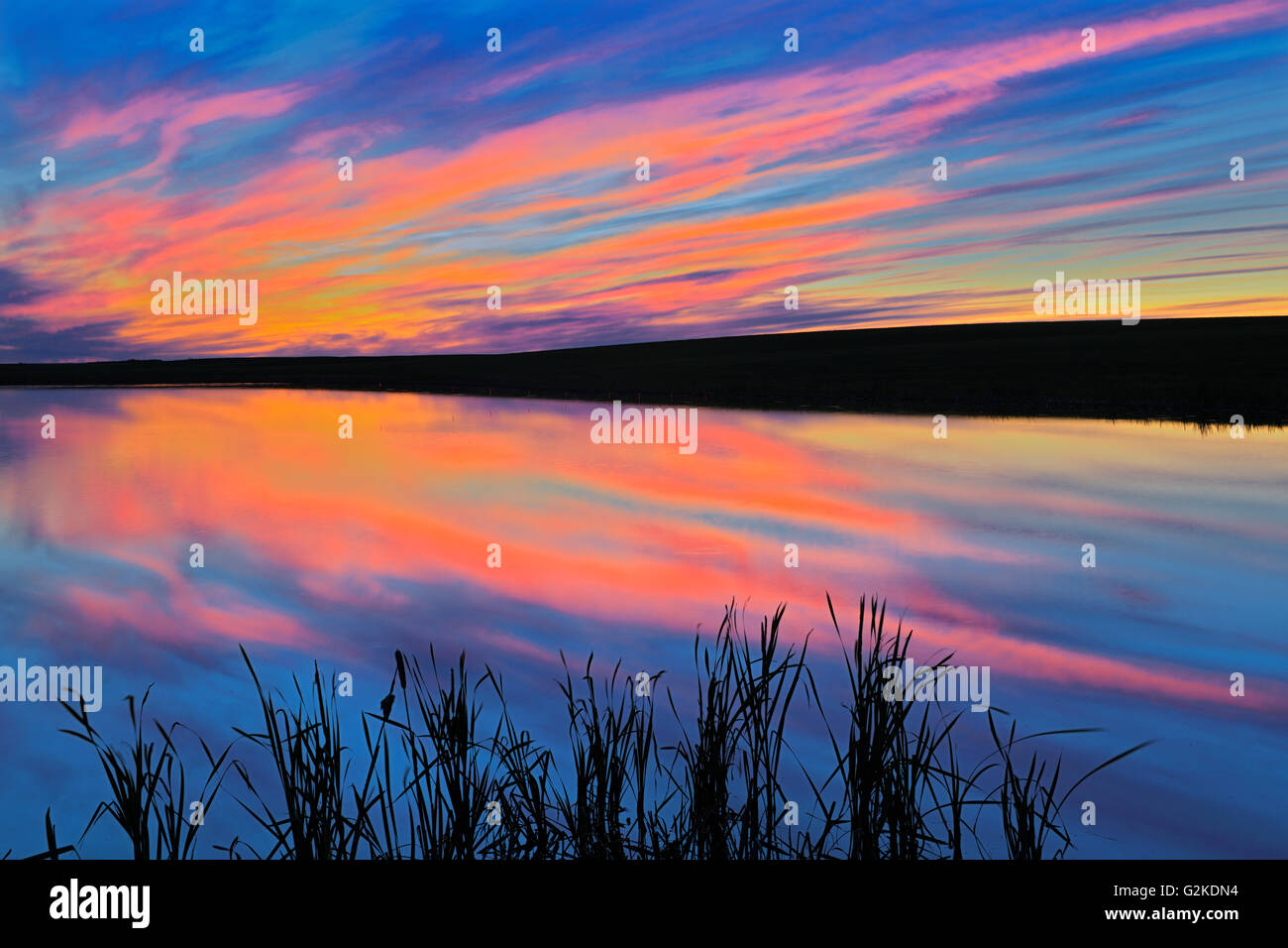 Sunset reflected in pond Viscount Saskatchewan Canada Stock Photo
