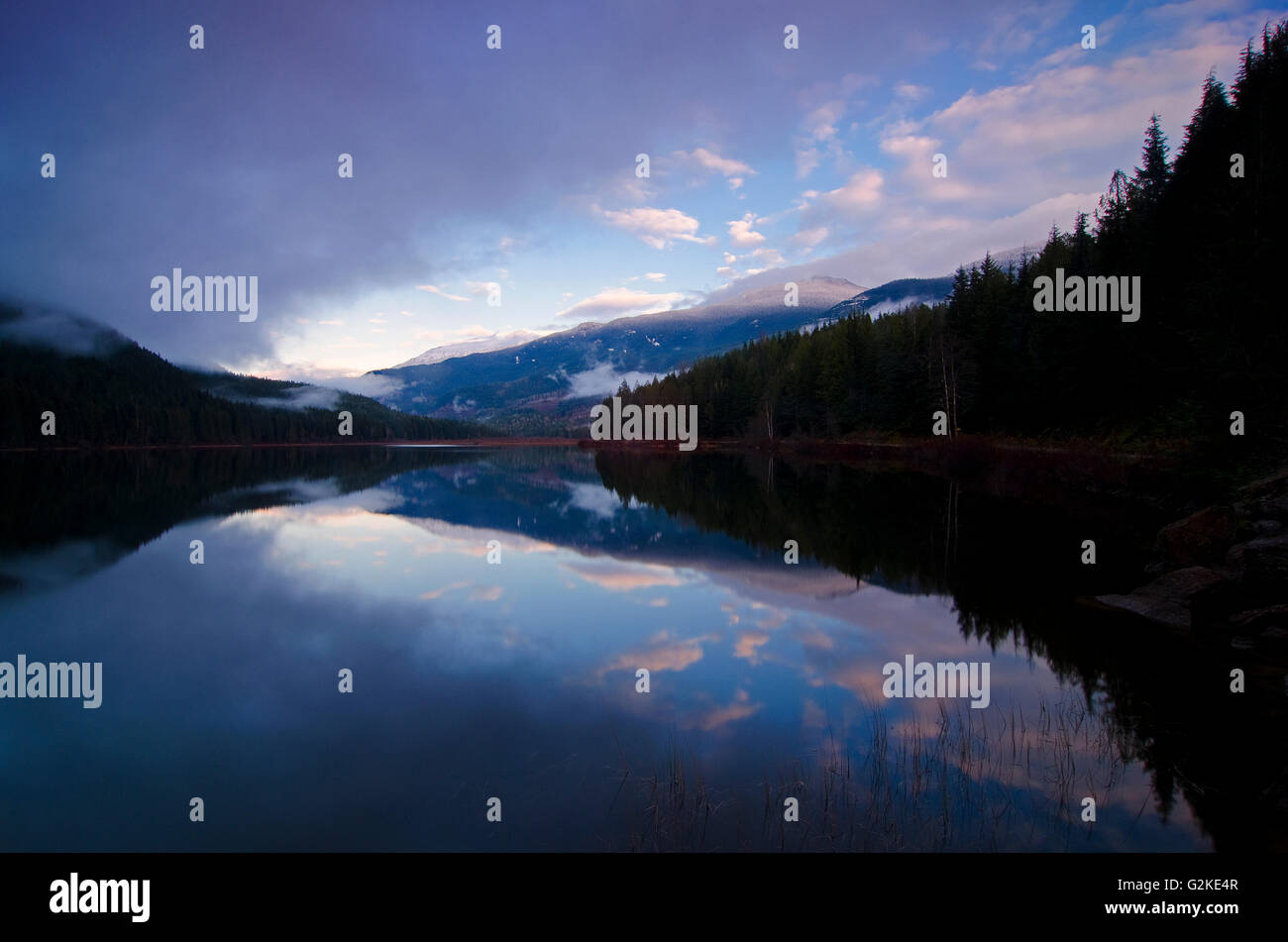 Clouds clear over Wap Lake, near Three Valley Gap in the Columbia Shuswap region of British Columbia, Canada Stock Photo