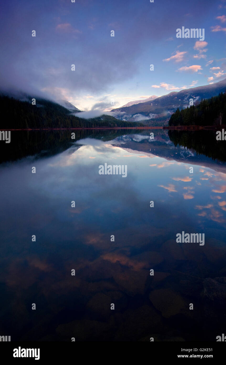 Clouds clear over Wap Lake, near Three Valley Gap in the Columbia Shuswap region of British Columbia, Canada Stock Photo