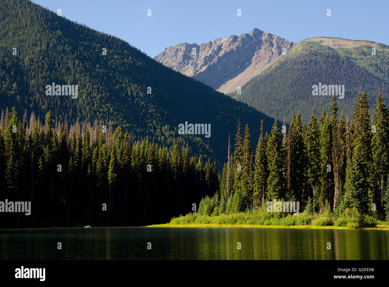 Fishing couple paddles Lightning Lake in E.C Manning Provincial Park