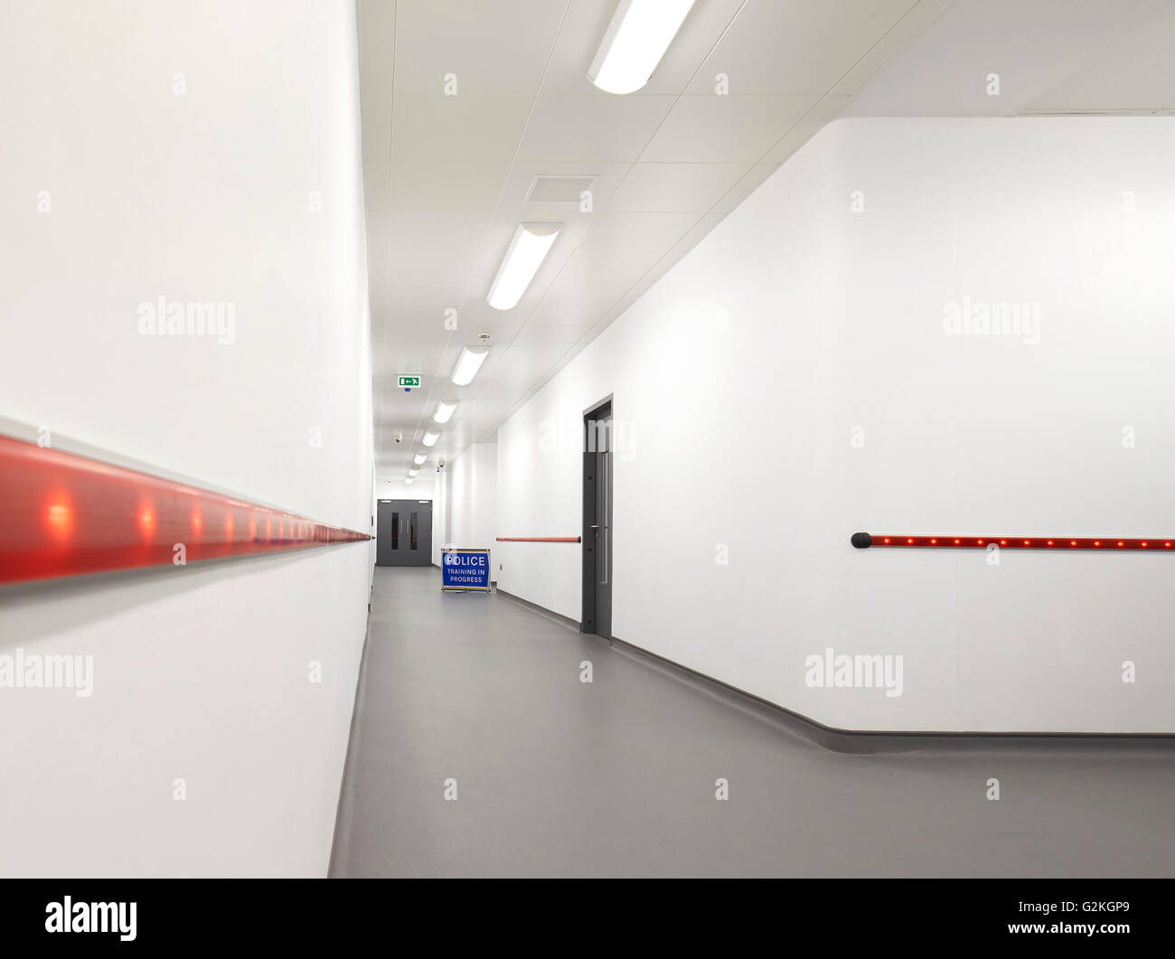 Corridor with lighting inserts. Keynsham Custody Suite and Prosecution and Investigation Facility, Keynsham, United Kingdom. Architect: Haverstock Associates LLP, 2014. Stock Photo