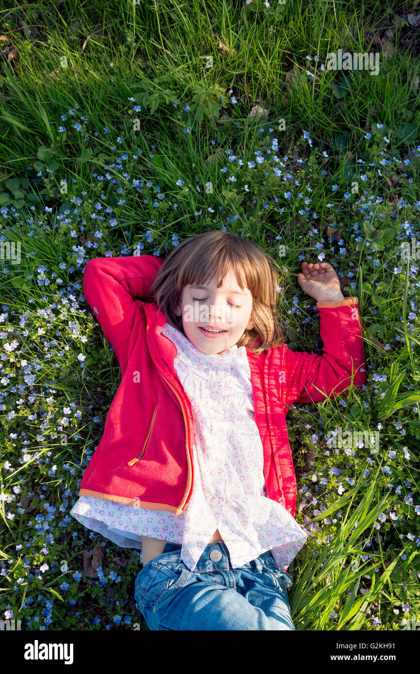 Portrait of little girl with eyes closed relaxing on a meadow Stock ...