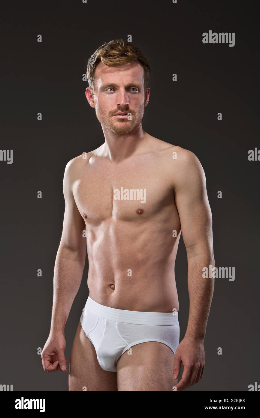 Portrait of muscular man wearing white underpants Stock Photo - Alamy