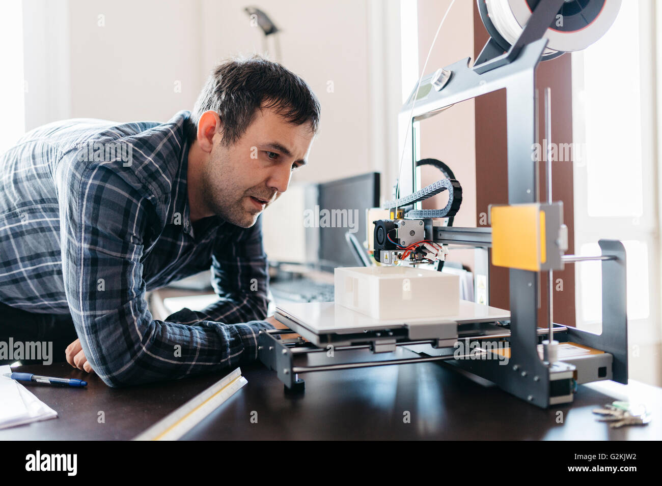 Worker controlling a model, 3D printer Stock Photo - Alamy