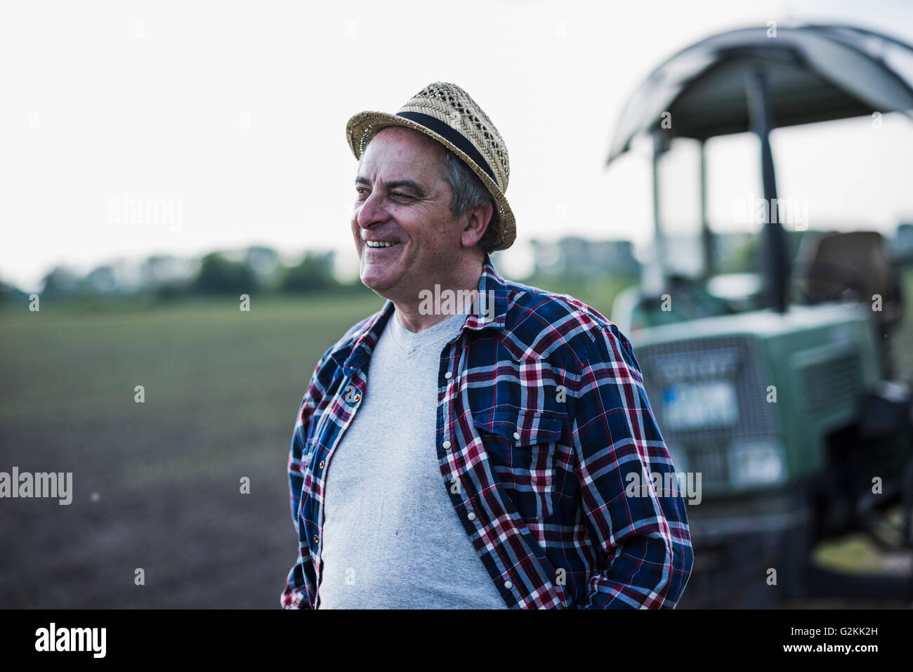 Portrait of smiling farmer in front of a field Stock Photo - Alamy