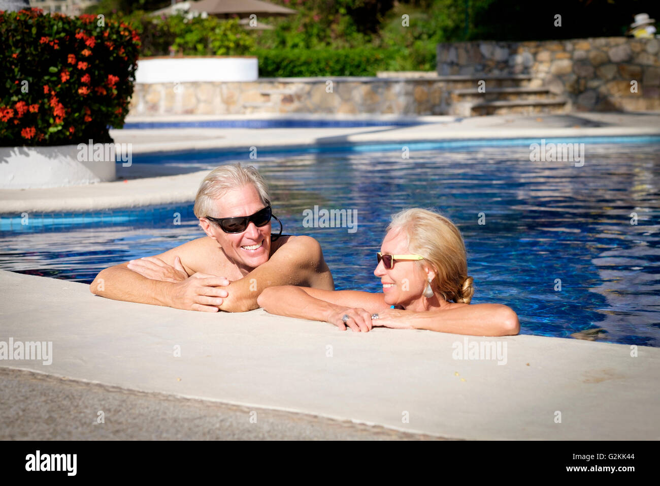 Happy senior couple in swimming pool Stock Photo - Alamy