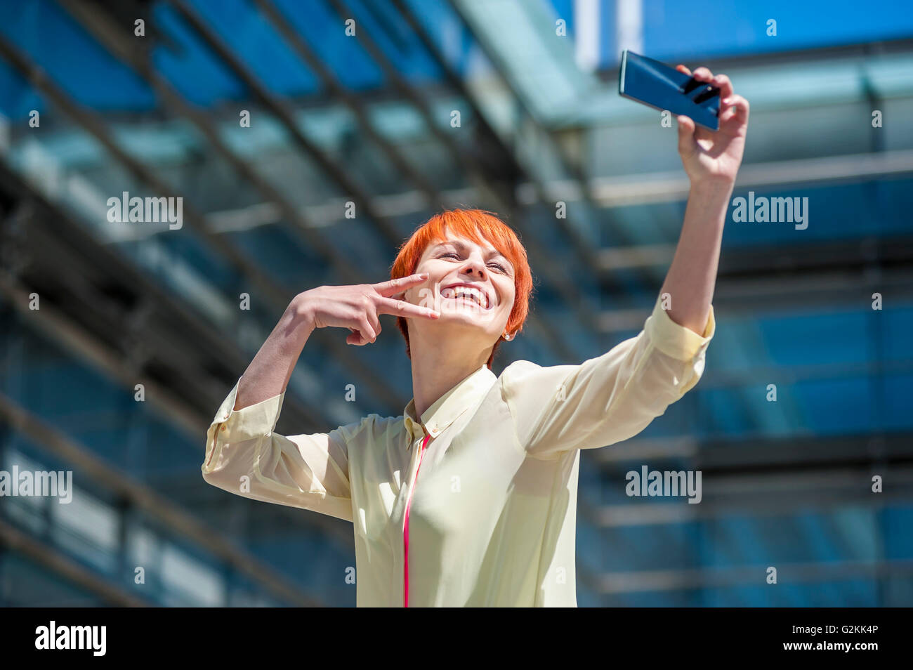 Happy young woman taking a selfie Stock Photo - Alamy