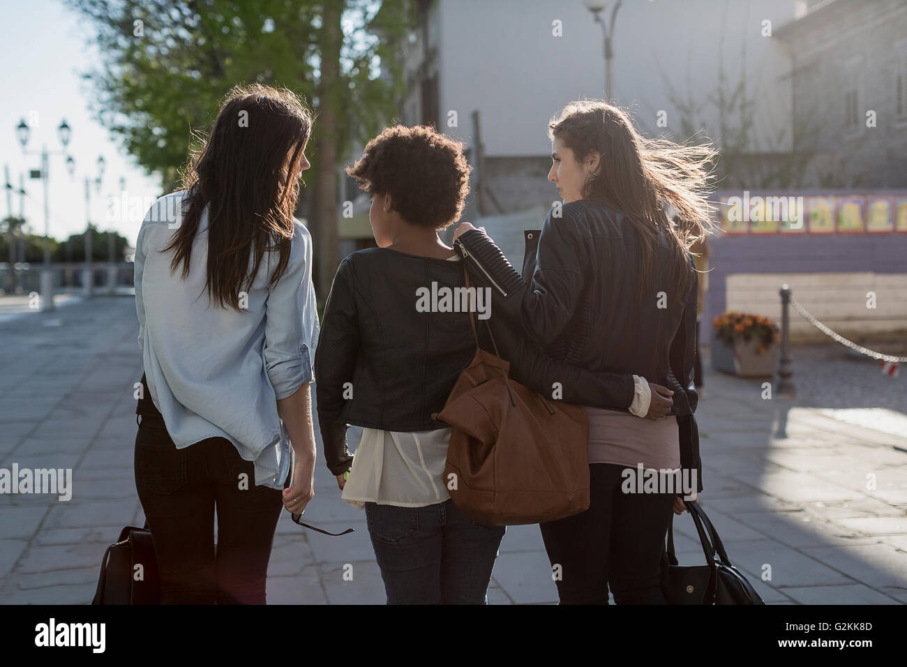 Three young women walking in the city, rear view Stock Photo - Alamy