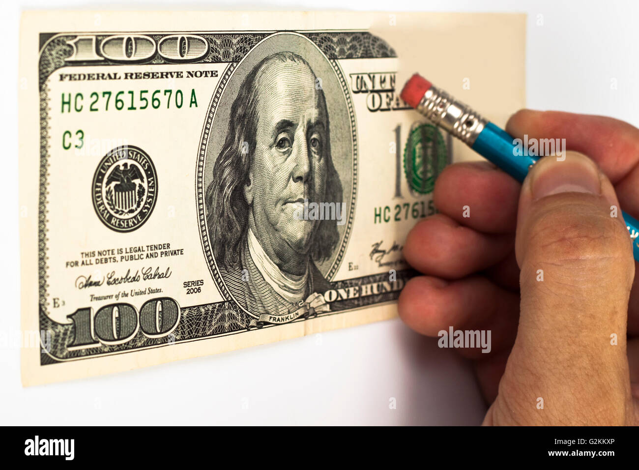 erasing a 100 dollar bill with a blue pencil whith red eraser Stock Photo -  Alamy