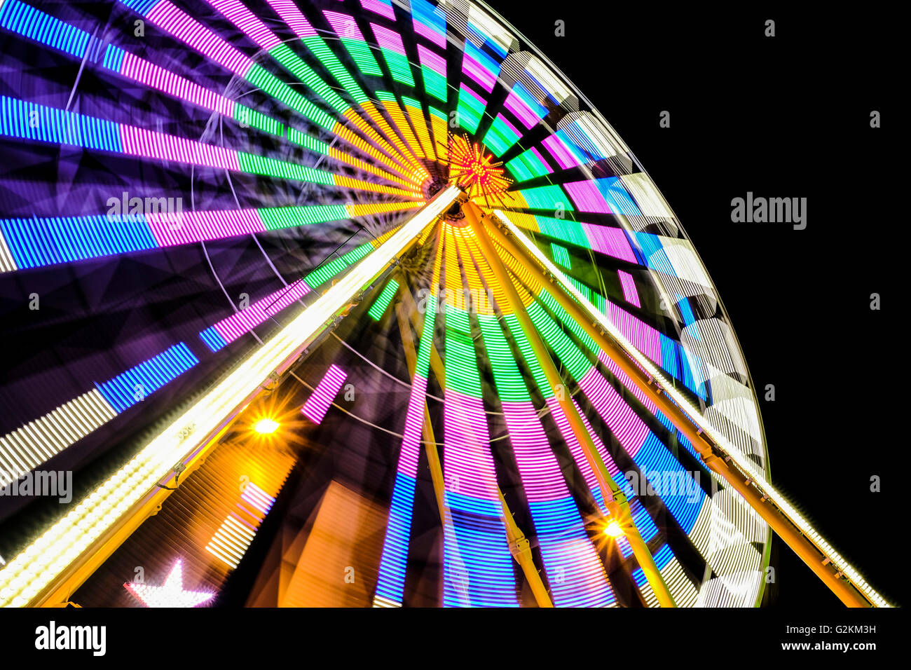 Turning colorful big wheel at night Stock Photo - Alamy