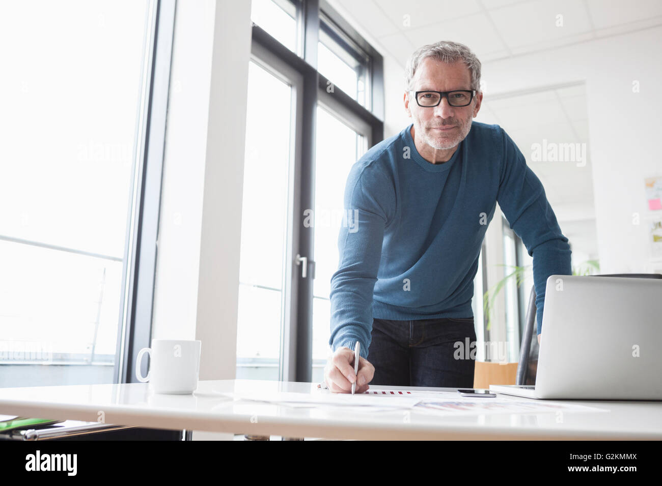 Mature man working in office, using laptop Stock Photo