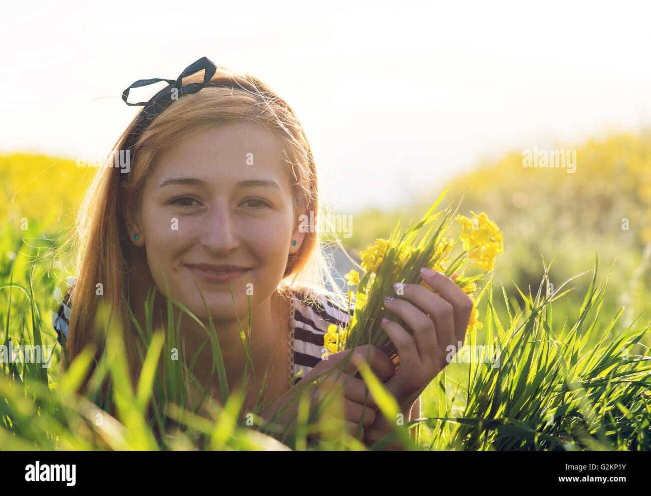 cute young girl in the middle of a field of yellow flowers Stock Photo ...