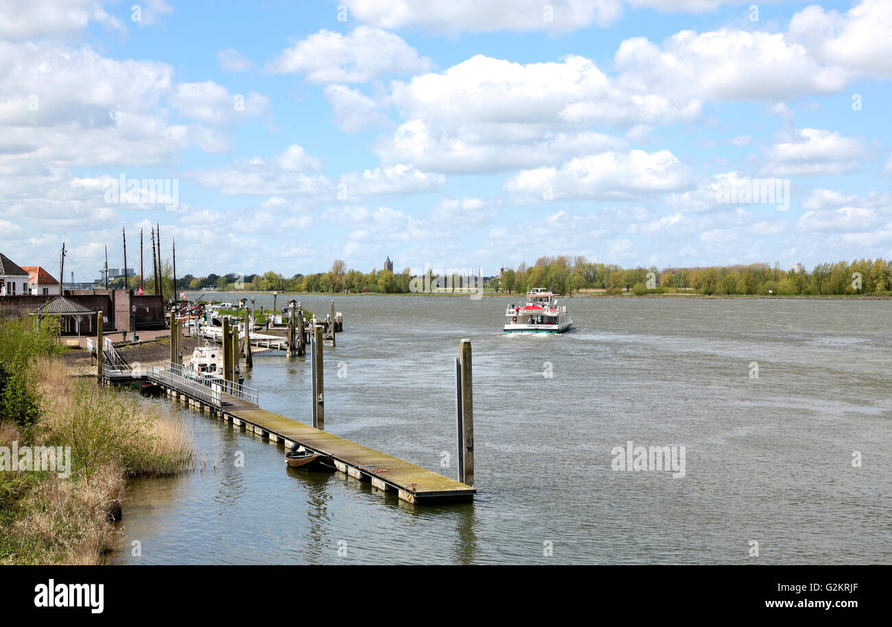 A ferry to Gorinchem on the river the Boven-Merwede seen from a little dutch town called Woudrichem Stock Photo