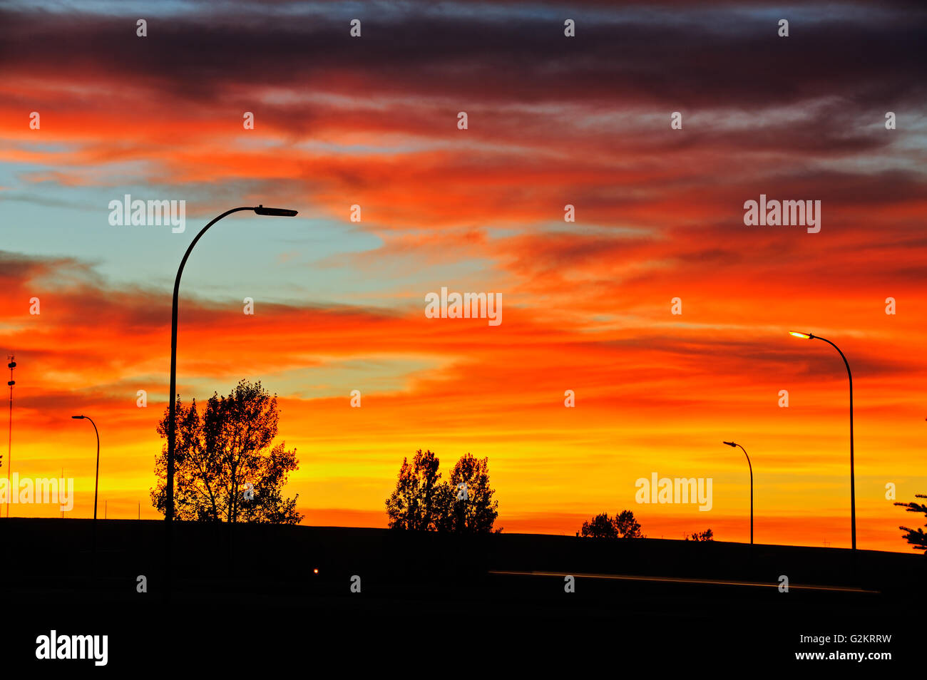 Blazing sky at sunrise on Trans Canada Highway Swift Current Saskatchewan Canada Stock Photo
