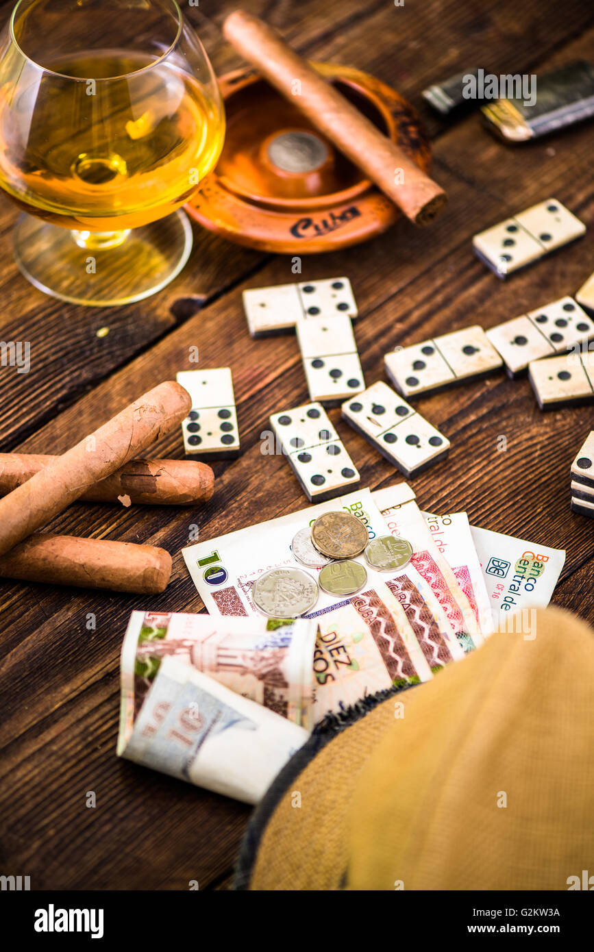 cuban domino game for money, cuban cigars and hat on table Stock Photo
