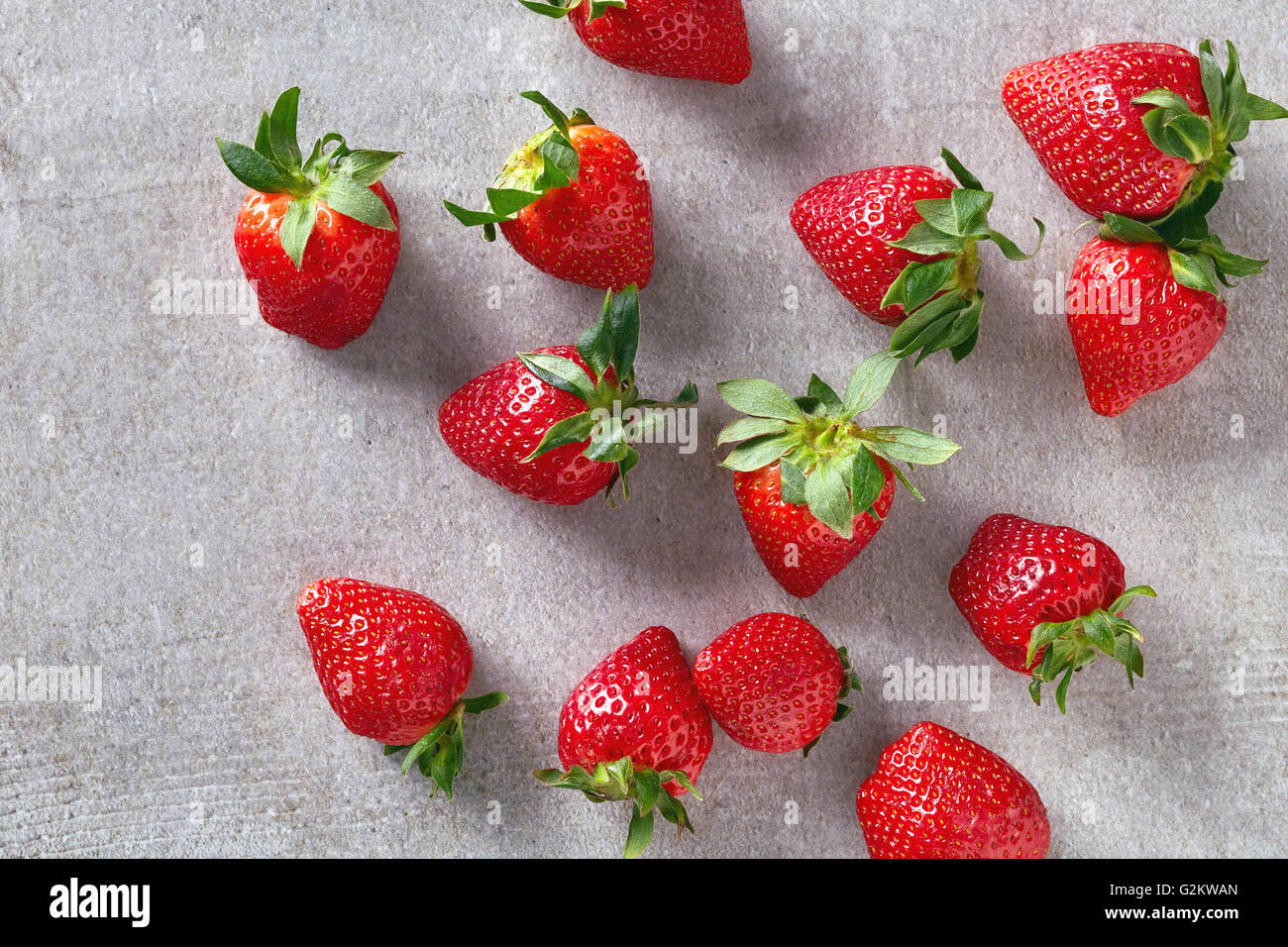 Ripe red strawberries on stone table, top view Stock Photo