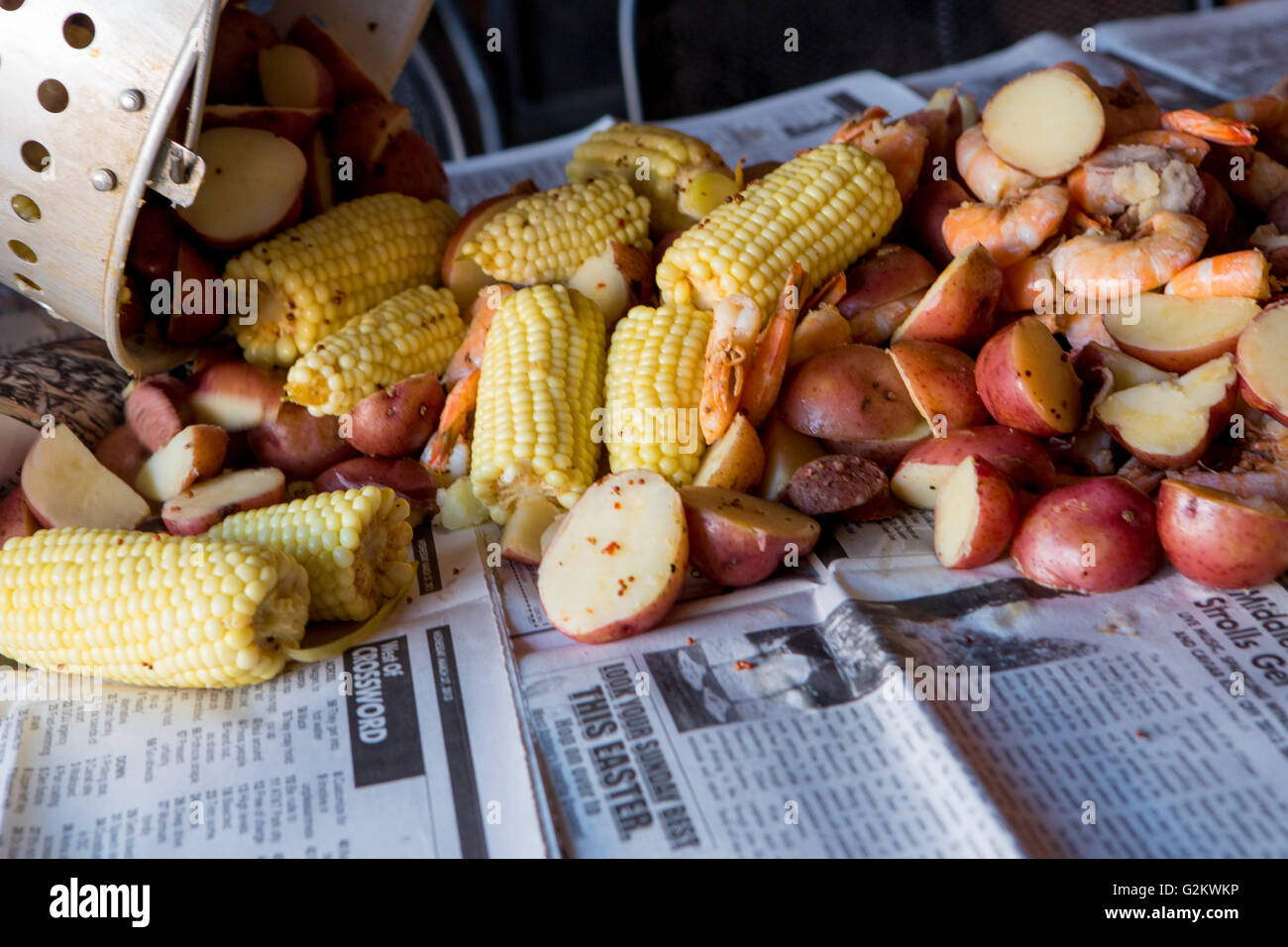 Low Country Boil with Shrimp, Corn, Sausage and Potatoes Being Poured