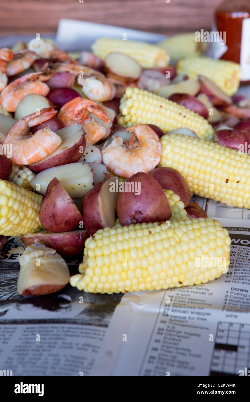 Low Country Boil with Shrimp, Corn, Sausage and Potatoes on Newspaper, Close Up Stock Photo