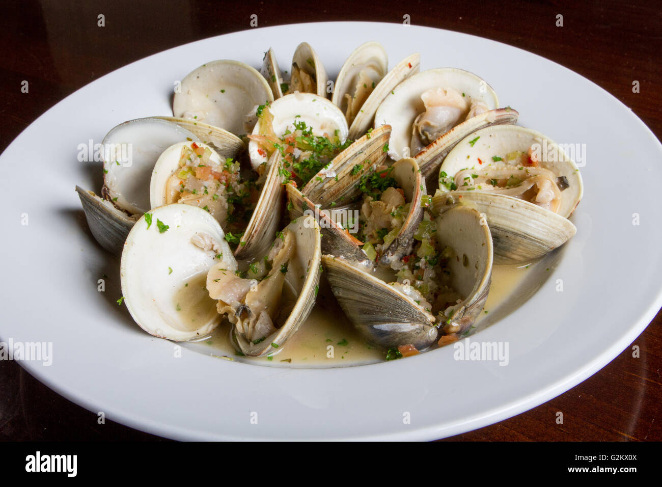 Bowl of Steamed Clams in White Sauce Stock Photo