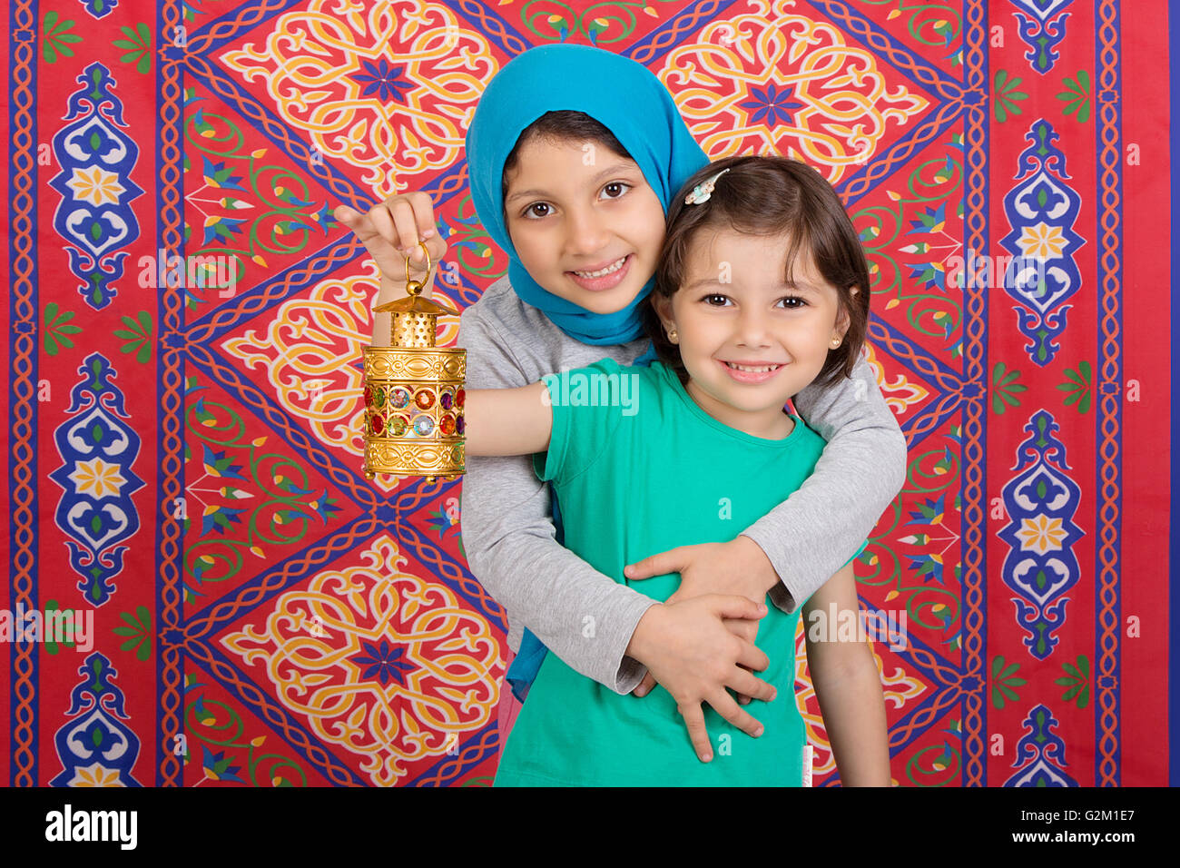Happy Family in Ramadan - Two Muslim sisters celebrating Ramadan Stock Photo