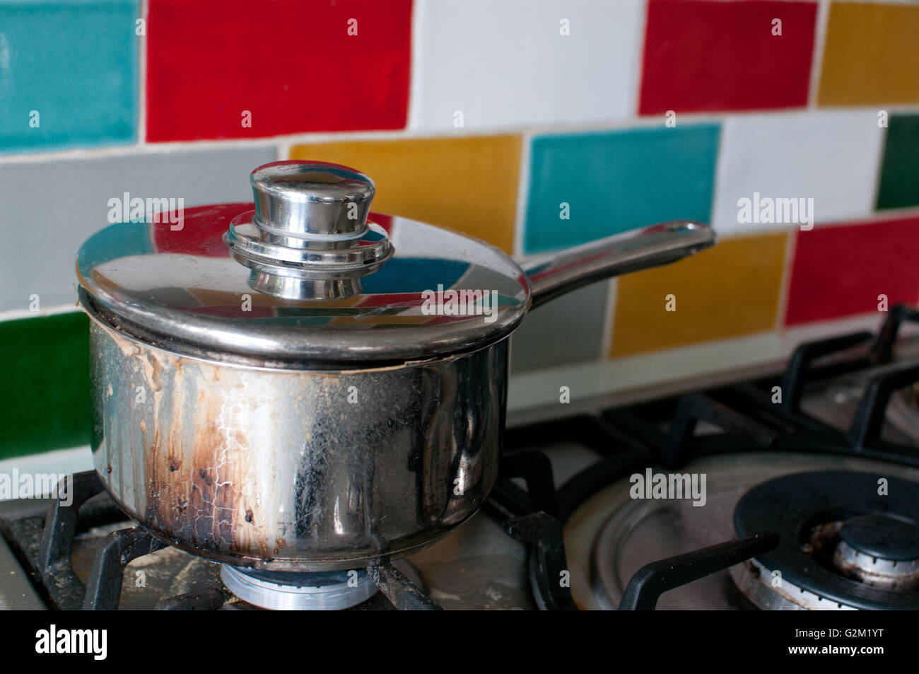 burnt saucepan on hob Stock Photo