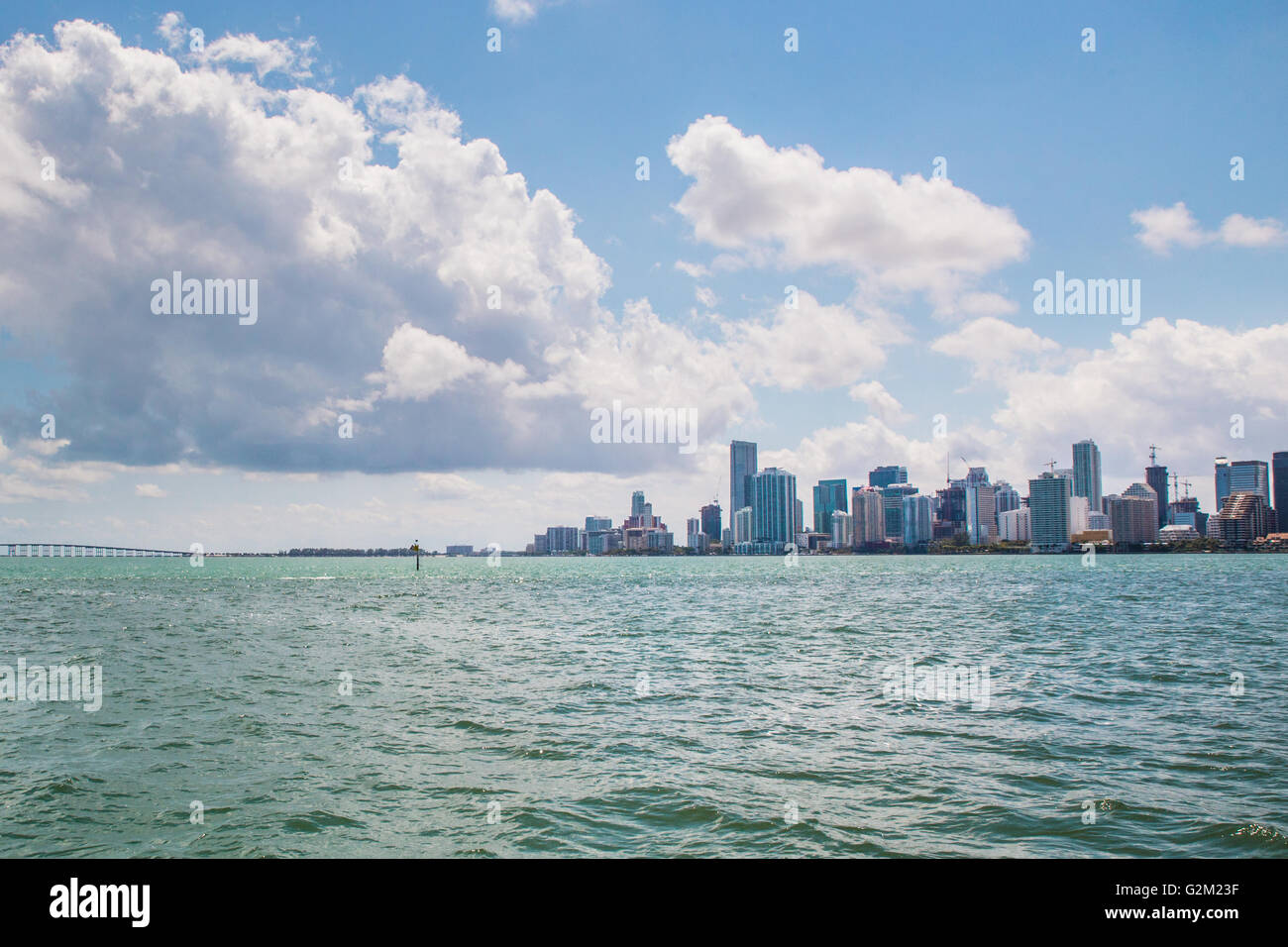 View of modern downtown Miami Florida, USA skyline seen from across Biscayne Bay with clouds overhead Stock Photo