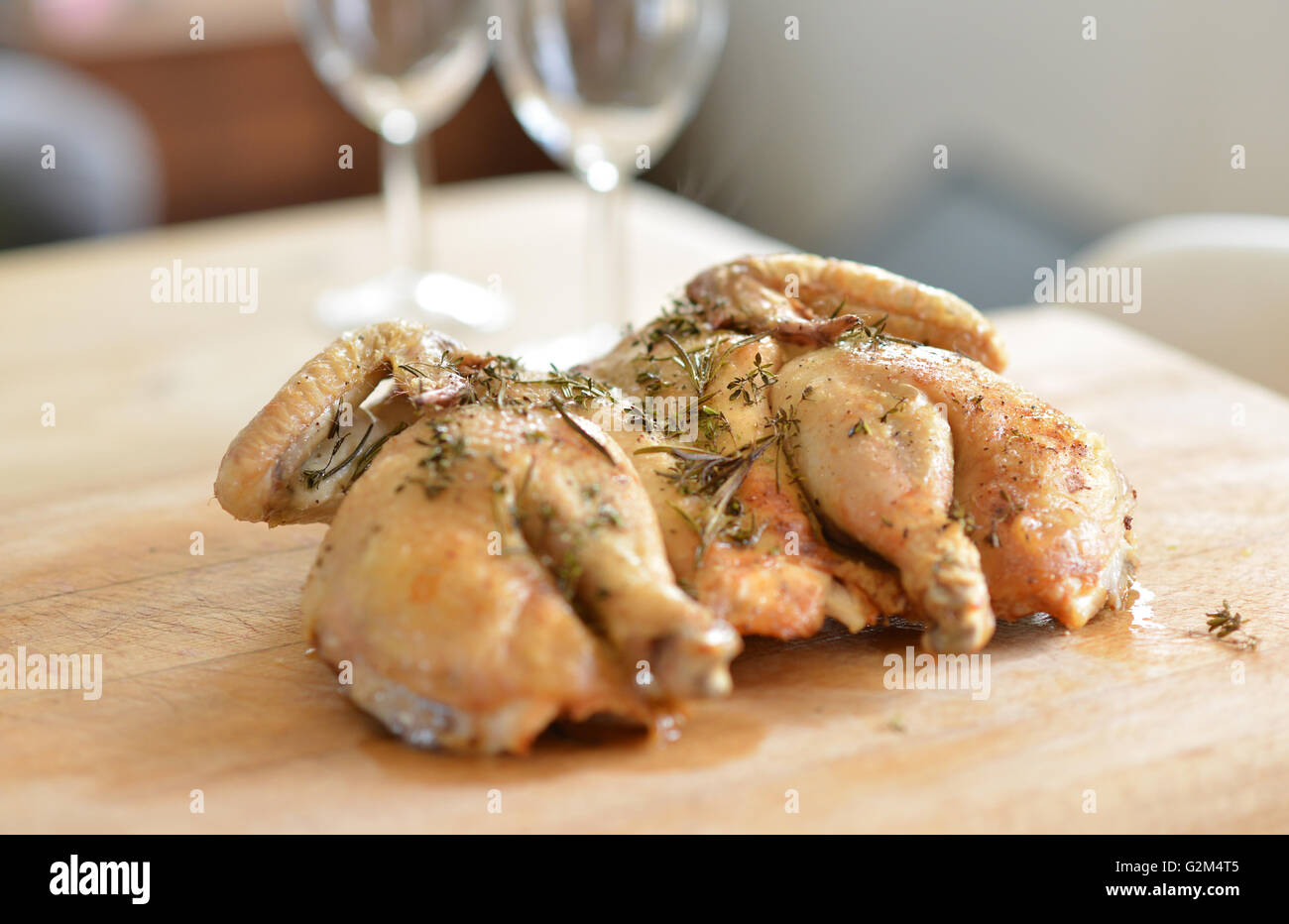Cooked spatchcock (butterfly) chicken and herbs Stock Photo